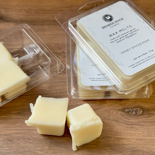 Wax melts in packaging on a wooden surface with 'Broken Rock Farms' branding.