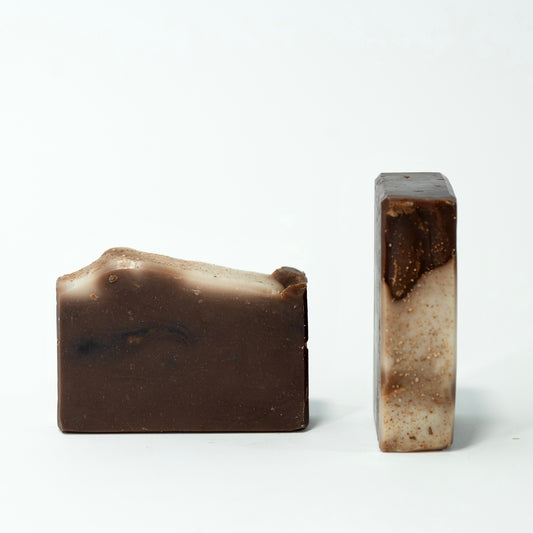 Two brown soap bars on a white background