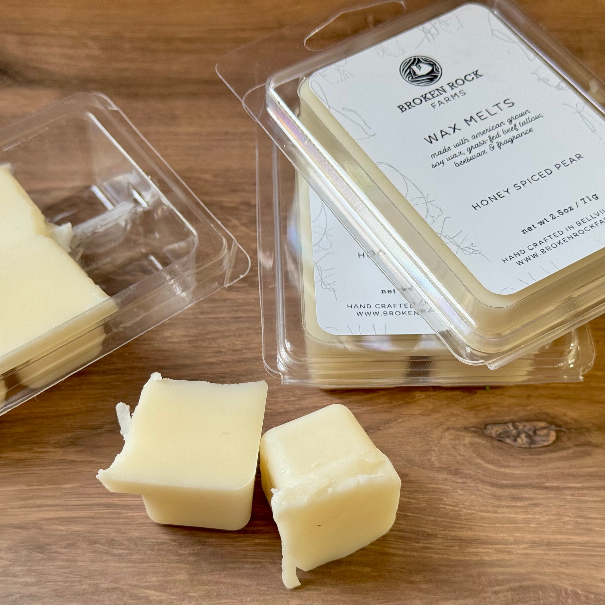 Wax melts in packaging on a wooden surface with 'Broken Rock Farms' branding.