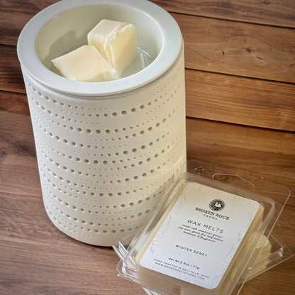 Wax melter with wax melts on a wooden surface